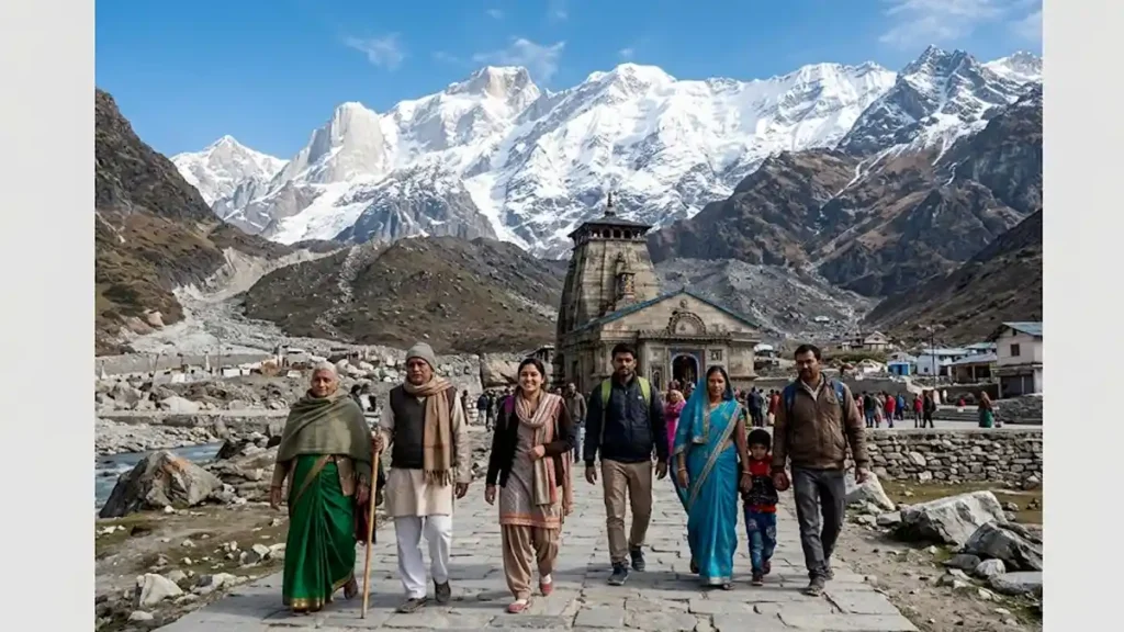 A group of Indian pilgrims standing in front of the scenic Kedarnath temple with Himalayan peaks in the background - చార్ ధామ్ యాత్ర రామ్తామీడియా.